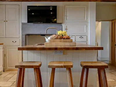a kitchen with a counter with two bar stools at 5 Bed in Cockermouth oc-91503 in Embleton