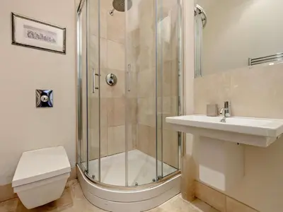a bathroom with a shower and a toilet and a sink at 5 Bed in Cockermouth oc-91503 in Embleton