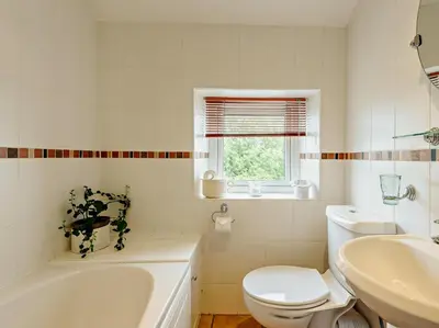 a bathroom with a toilet and a tub and a sink at 1 Bed in Gilcrux 92218 in Gilcrux