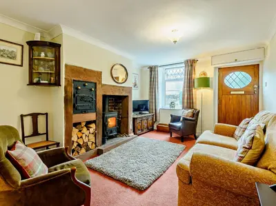 a living room with two couches and a fireplace at 1 Bed in Gilcrux 92218 in Gilcrux