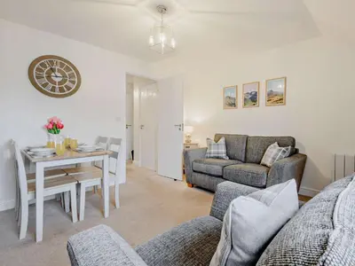 a living room with a table and a couch at 2 Bed in Keswick 91901 in Keswick