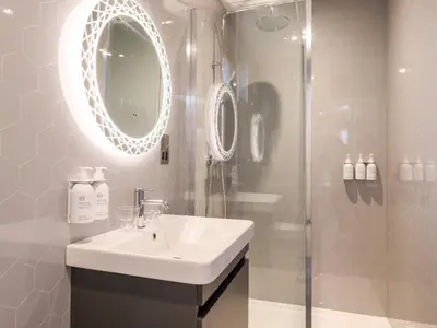 a bathroom with a sink and a shower at Herdwick Cabin in Penrith