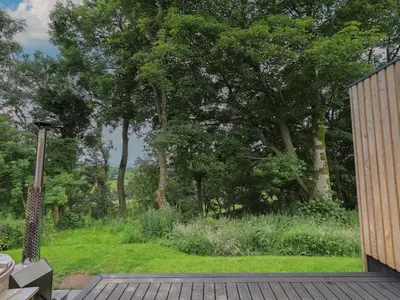 a view of a garden from the deck of a house at Herdwick Cabin in Penrith