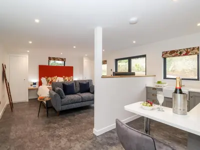 a living room with a couch and a table at The Gardener's Retreat in Penrith