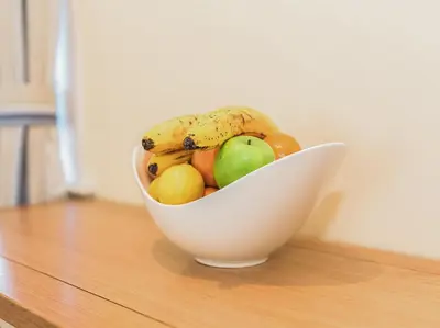 a bowl of fruit sitting on a table at High Auchenlarie Cottage in Carsluith