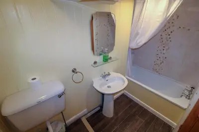 a bathroom with a sink and a toilet and a shower at Carlton Cottage all ground floor, centrally located in Keswick in Keswick