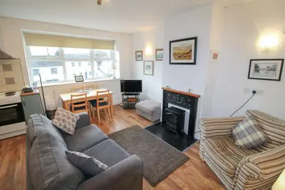 a living room with a couch and a fireplace at Emilys Nook Ireby, budget accommodation with fell views in Ireby