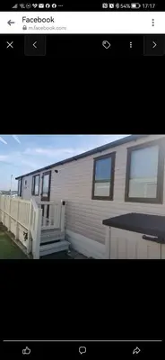 a mobile home with a porch and a building at Birds Eye View in Mainsriddle