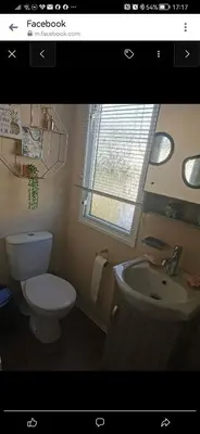 a bathroom with a toilet and a sink at Birds Eye View in Mainsriddle