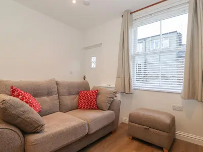 a living room with a couch and a window at Jack's Cottage in Keswick