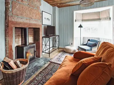 a living room with a couch and a fireplace at Top Lodge in Carlisle