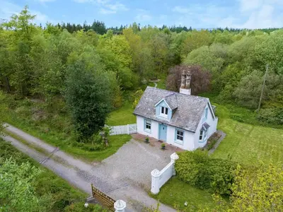 an aerial view of a white house in the woods at Top Lodge in Carlisle