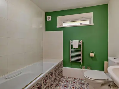 a green bathroom with a tub and a toilet at 2 Bed in Keswick oc-28383 in Braithwaite
