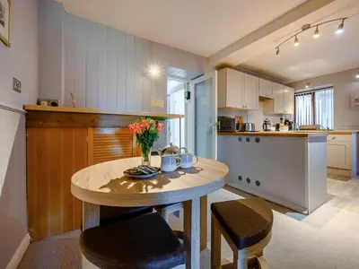 a kitchen with a table and chairs and a table and a kitchen at 2 Bed in Keswick 28377 in Braithwaite