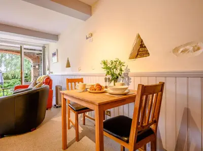 a living room with a wooden table and chairs at 1 Bed in Keswick oc-28382 in Braithwaite