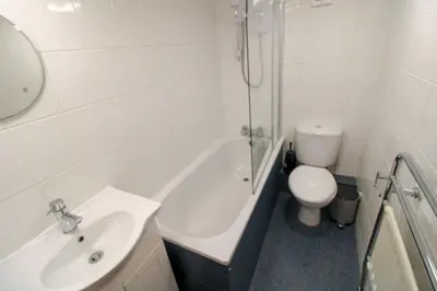a white bathroom with a sink and a toilet at Grasmere View, stunning views over Grasmere Lake, ideal romantic break in Grasmere