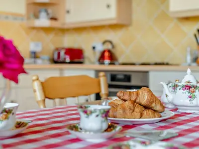 a table with croissants and cups and croissants on it at 2 Bed in Bassenthwaite 93463 in Ireby
