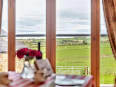 a window with a view of a green field at 2 Bed in Bassenthwaite 93463 in Ireby