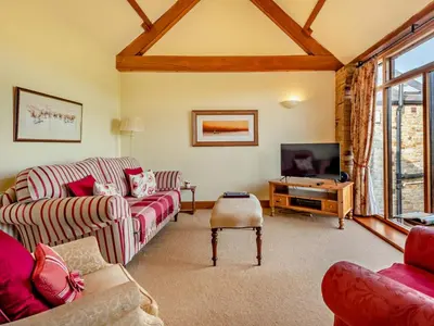 a living room with two couches and a tv at 2 Bed in Bassenthwaite 93463 in Ireby