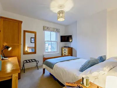 a bedroom with a bed and a desk and a window at 1 Bed in Keswick 93386 in Keswick