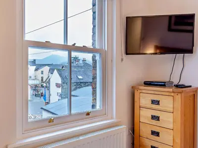 a room with a window and a tv and a dresser at 1 Bed in Keswick 93386 in Keswick