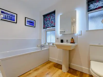 a bathroom with a sink and a bath tub at 1 Bed in Keswick 93386 in Keswick
