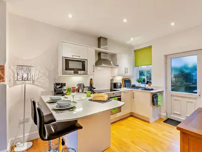 a kitchen with white cabinets and a counter top at 1 Bed in Keswick 93386 in Keswick