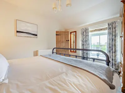 a bedroom with a bed and a window at 2 Bed in Bridekirk 93280 in Bridekirk