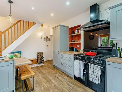 a kitchen with blue cabinets and a stove at 1 Bed in Cockermouth oc-93147 in Cockermouth