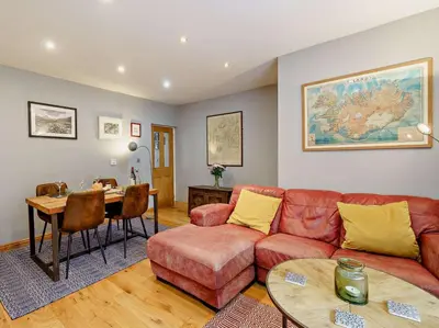 a living room with a couch and a table at 1 Bed in Cockermouth oc-93147 in Cockermouth