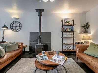 a living room with a couch and a wood stove at 2 Bed in Ambleside oc-sz500 in Grasmere