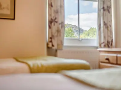 a bedroom with two beds and a window at 3 Bed in Chapel Stile SZ161 in Chapel Stile