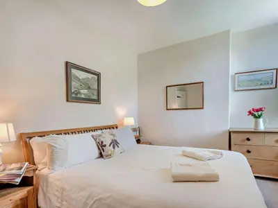 a bedroom with a white bed with two towels on it at 3 Bed in Chapel Stile SZ161 in Chapel Stile