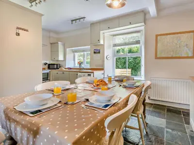 a kitchen with a table with a table cloth on it at 3 Bed in Chapel Stile SZ161 in Chapel Stile