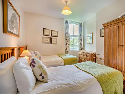 a bedroom with two beds and a window at 3 Bed in Chapel Stile SZ161 in Chapel Stile