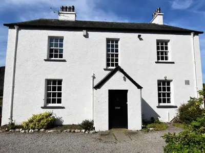 a white brick house with a black door at 4 Bed in Cockermouth oc-85979 in Buttermere