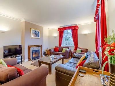 a living room with couches and a tv and a fireplace at 4 Bed in Cockermouth oc-85979 in Buttermere