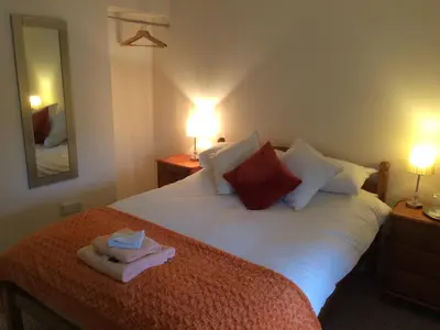 a bedroom with a bed with a towel on it at The Village Inn in Kirtlebridge
