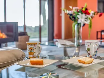 two plates of food on a glass table with two cups at 4 Bed in Broughton Mills 75286 in Seathwaite