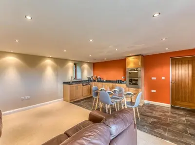a living room with a leather couch and a table at 4 Bed in Broughton Mills 75286 in Seathwaite