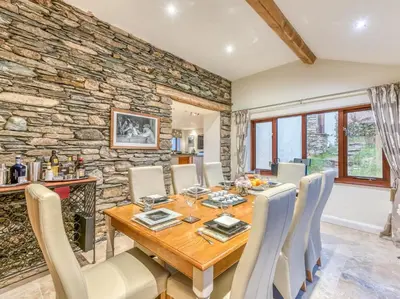 a dining room with a wooden table and chairs at 4 Bed in Broughton Mills 75286 in Seathwaite
