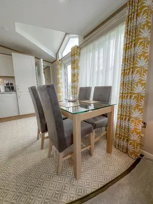a dining room with a table and chairs at Serena Holiday Caravan in Bassenthwaite