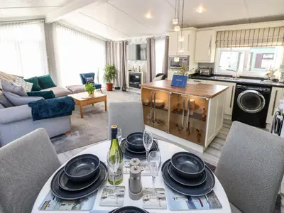 a kitchen and living room with a table and chairs at A and C Lodge-Plot 21 in Carlisle