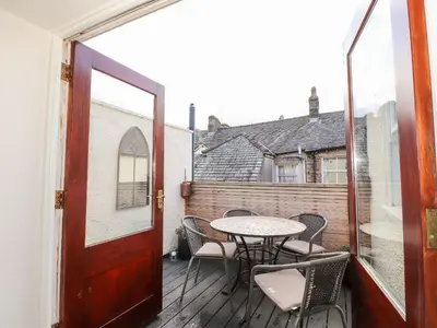 an open door to a balcony with a table and chairs at Walla Crag, Royal Oak House in Keswick