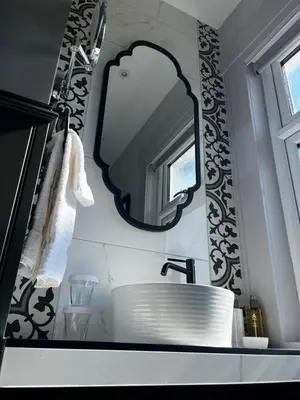 a bathroom with a sink and a mirror on the wall at Abbotsford Hotel in Ayr