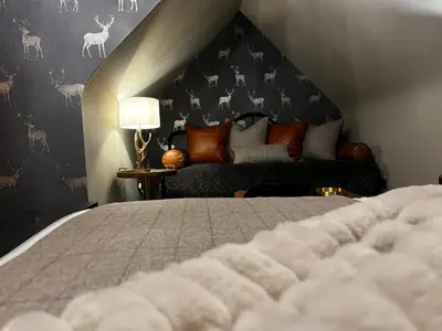 a bedroom with a large bed and a couch at Abbotsford Hotel in Ayr