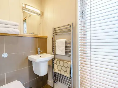 a bathroom with a sink and a mirror at 2 Bed in Caldbeck 80562 in Caldbeck