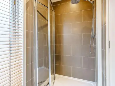 a shower stall with a glass door in a bathroom at 2 Bed in Caldbeck 80562 in Caldbeck