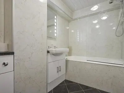 a white bathroom with a tub and a sink at 1 Bed in Keswick SZ468 in Keswick