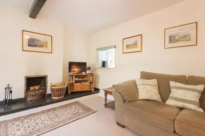 a living room with a couch and a fireplace at 2 Bed in Eskdale SZ346 in Santon Bridge